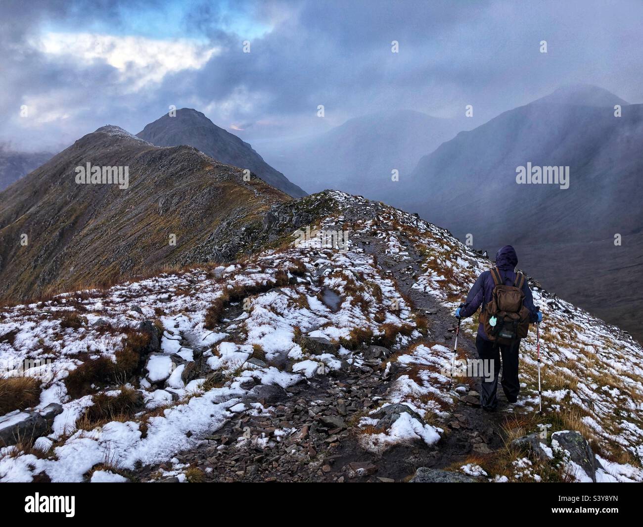 Walkers on the path and slopes of a snow covered Munro Buachaille Etive Beag, Glencoe, Scotland - Smartphone Captured Stock Image