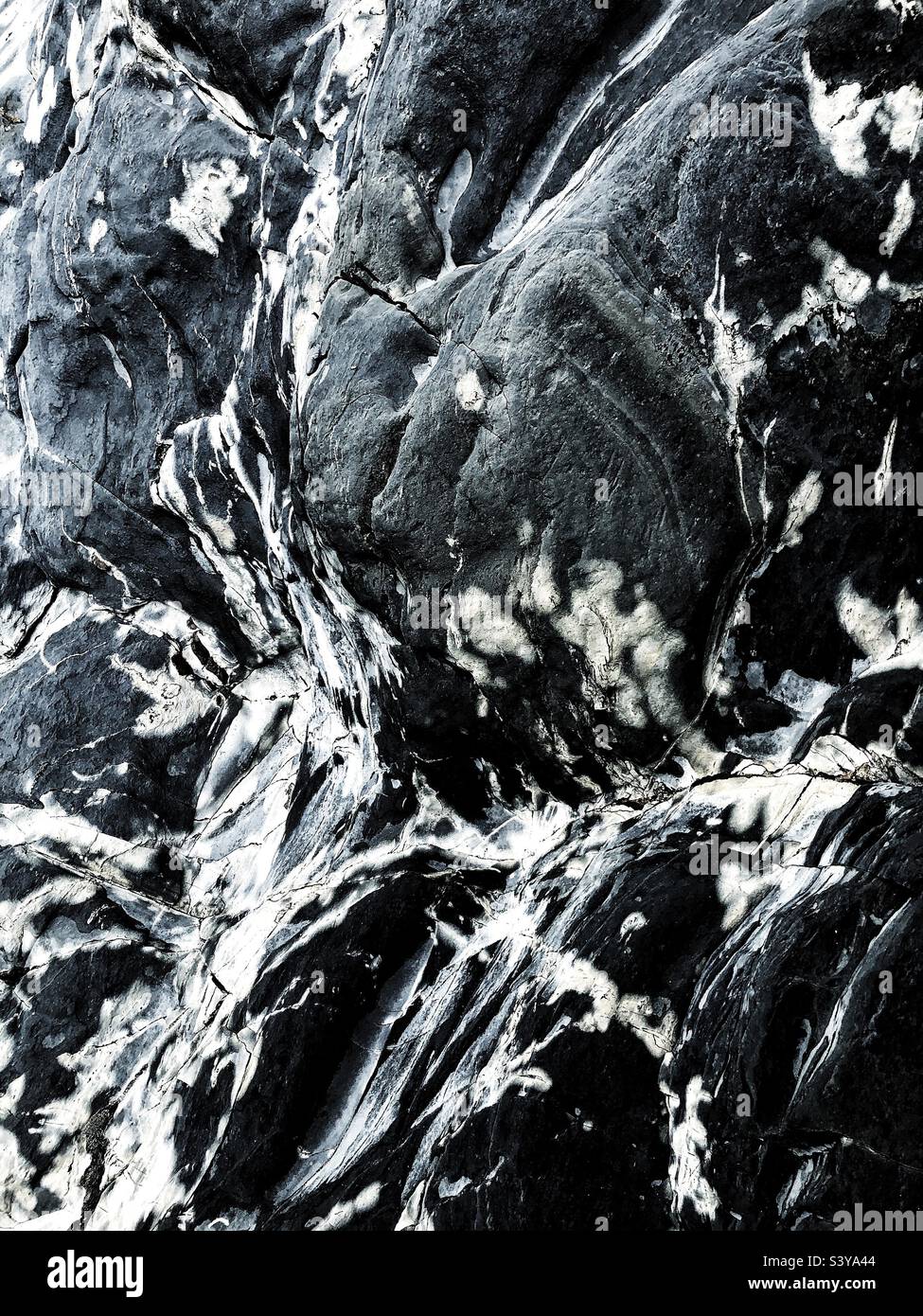 Full frame textured background of smooth marbled stone on a cliff cross section Stock Photo