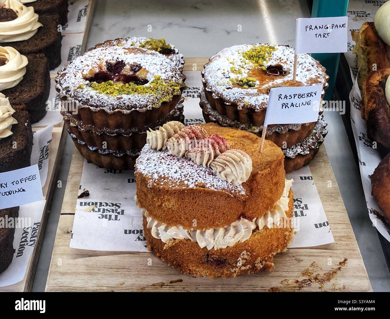 Frangipane Tart and Raspberry Praline in bakery shop window - Smartphone Captured Stock Image