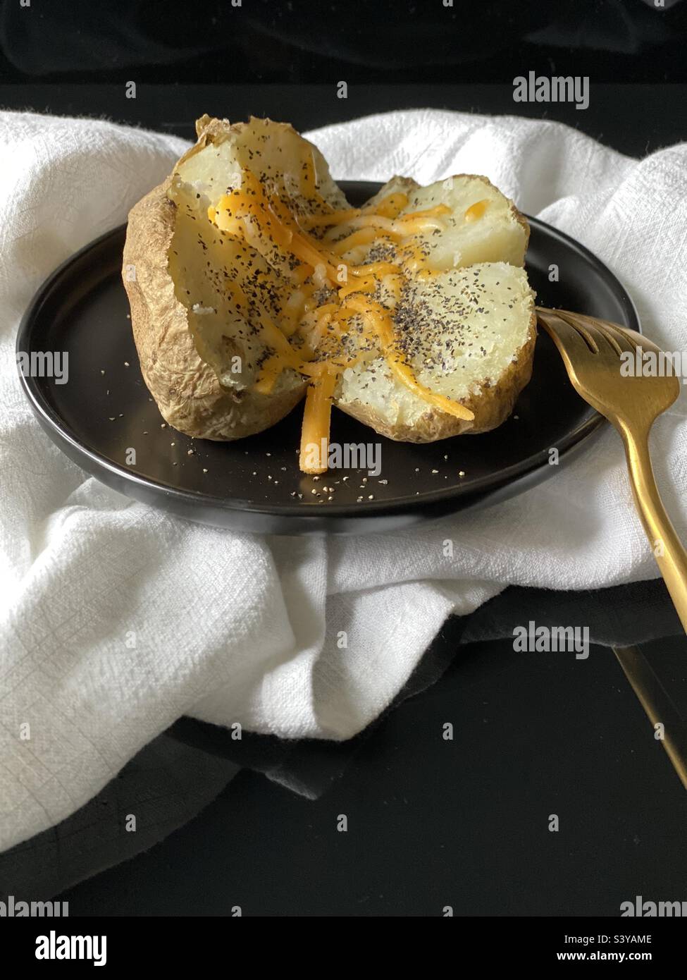 Simple baked potato with cheese Stock Photo