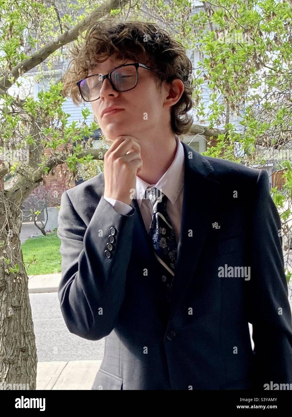 Young man poses pensively dressed for his prom. - Smartphone Captured Stock Image