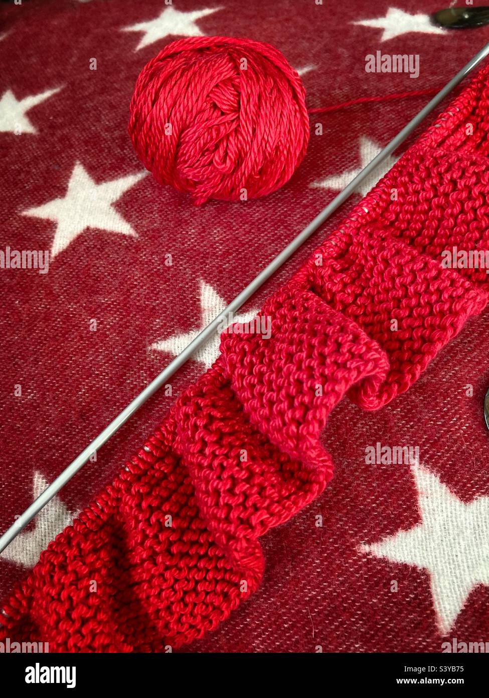 Winter knitting with red wool Stock Photo