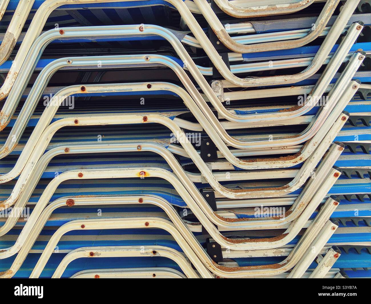Stacked sun beds at end of the season Stock Photo