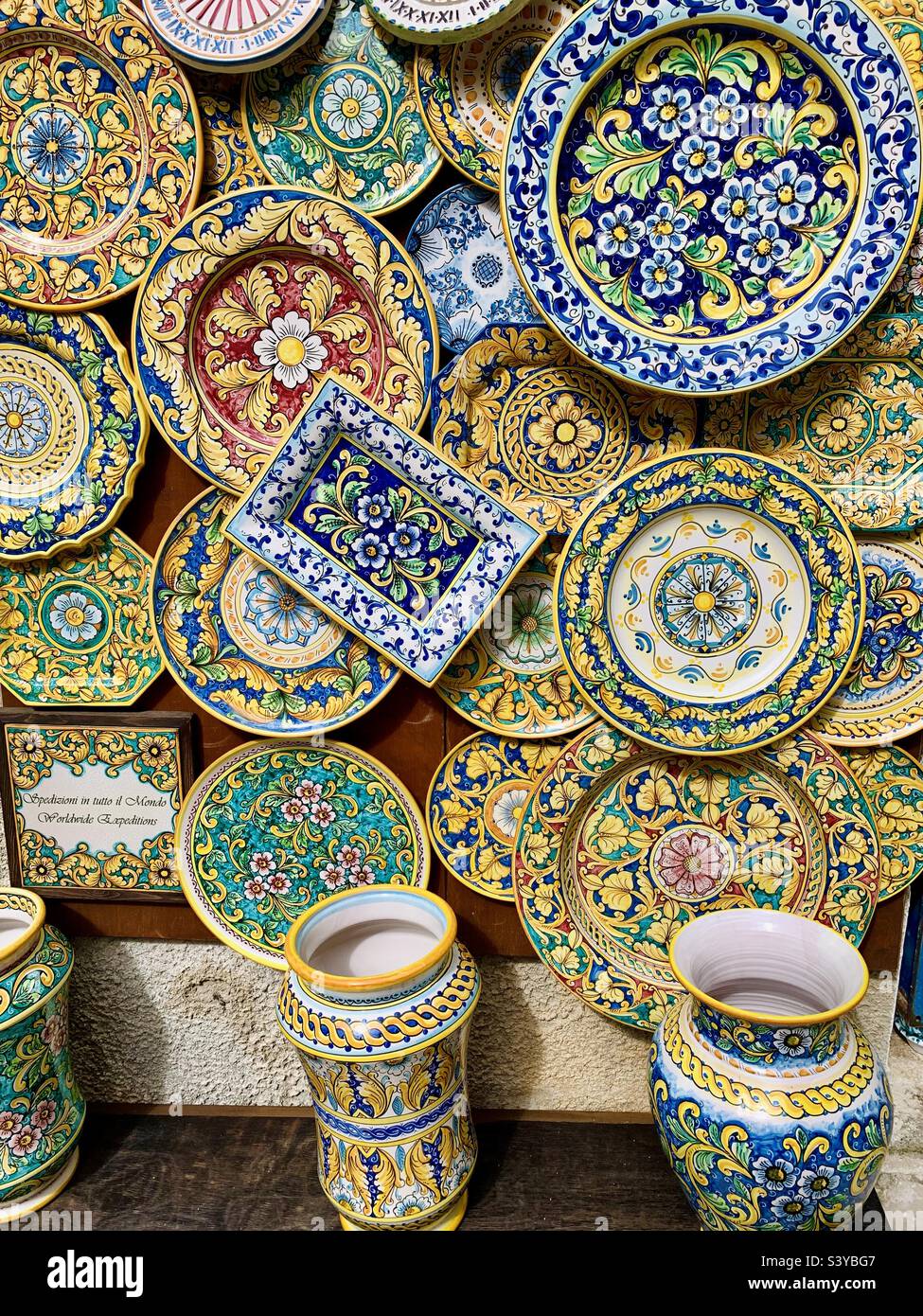 Colorful ceramic plates souvenirs on sale in the medieval hill top town of Erice, Trapani, Sicily, Italy. - Smartphone Captured Stock Image