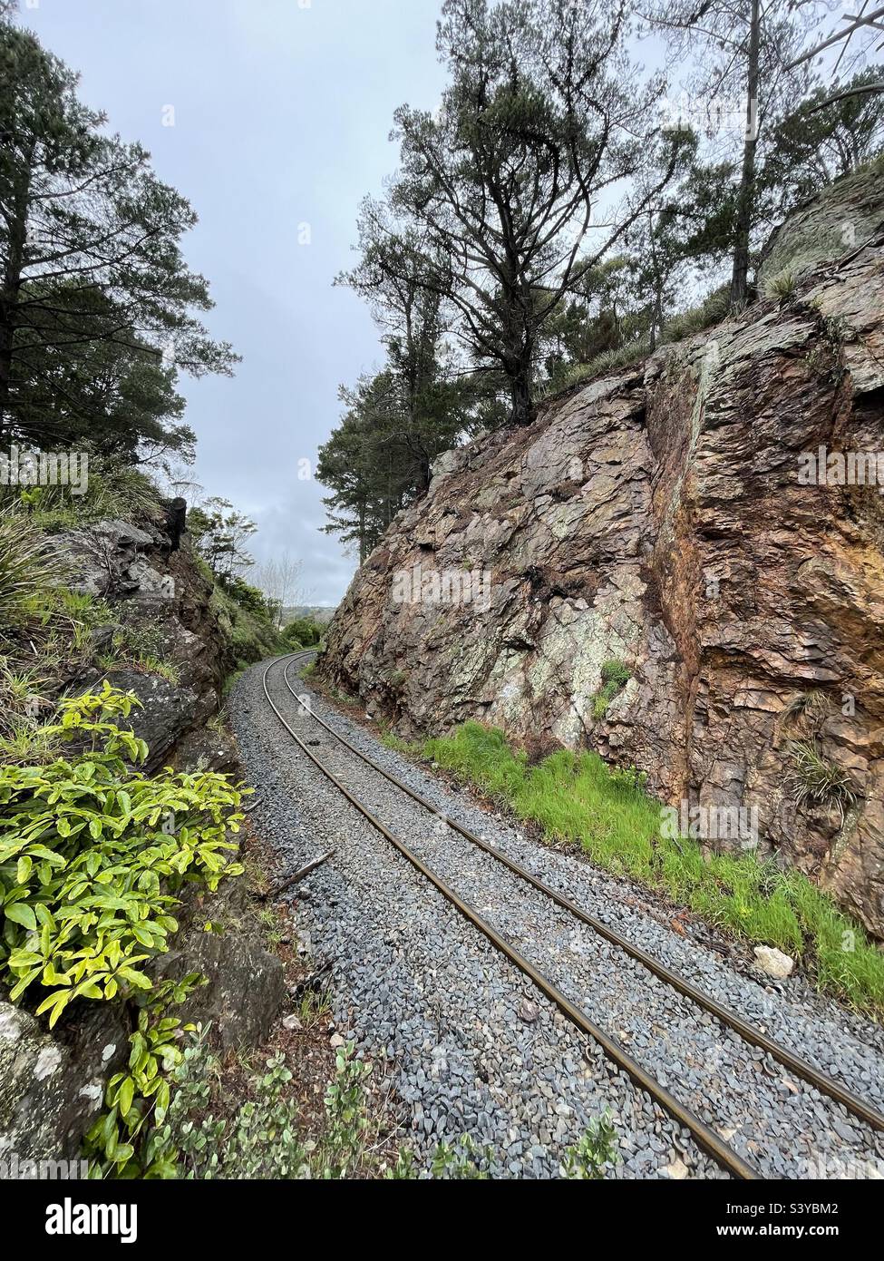 Train track cut through rock Stock Photo Alamy