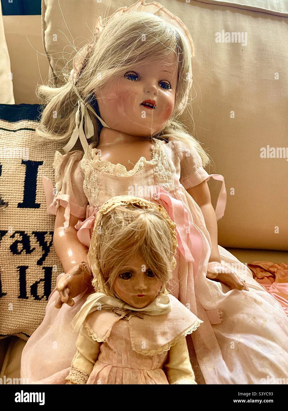 Two antique dolls in pink dresses Stock Photo