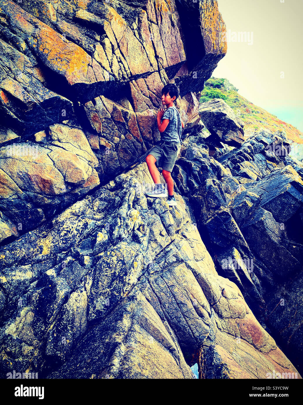 A little boy is doing rock climbing Stock Photo - Alamy