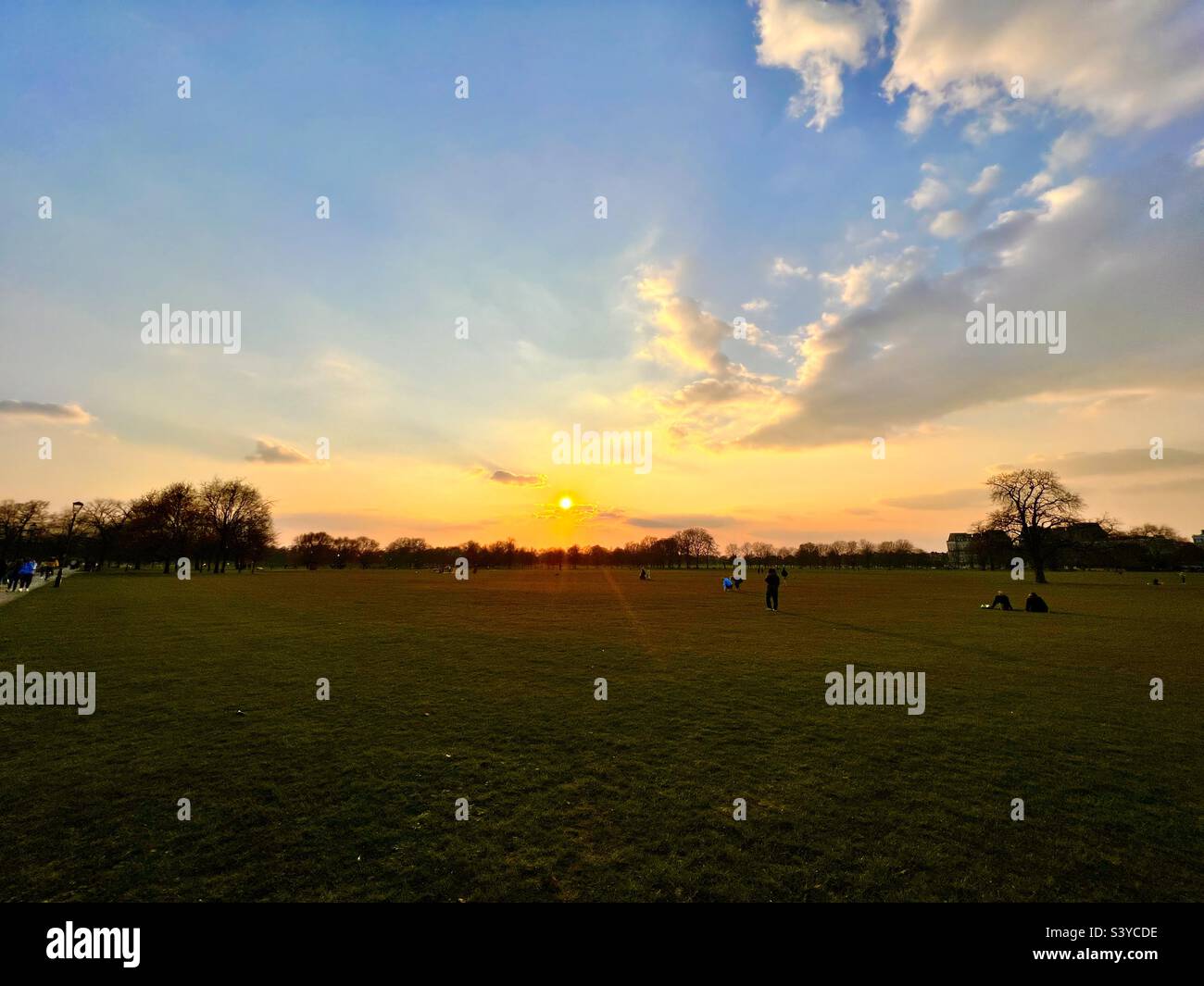 Sunset over Clapham Common in London England in winter with young professionals Stock Photo