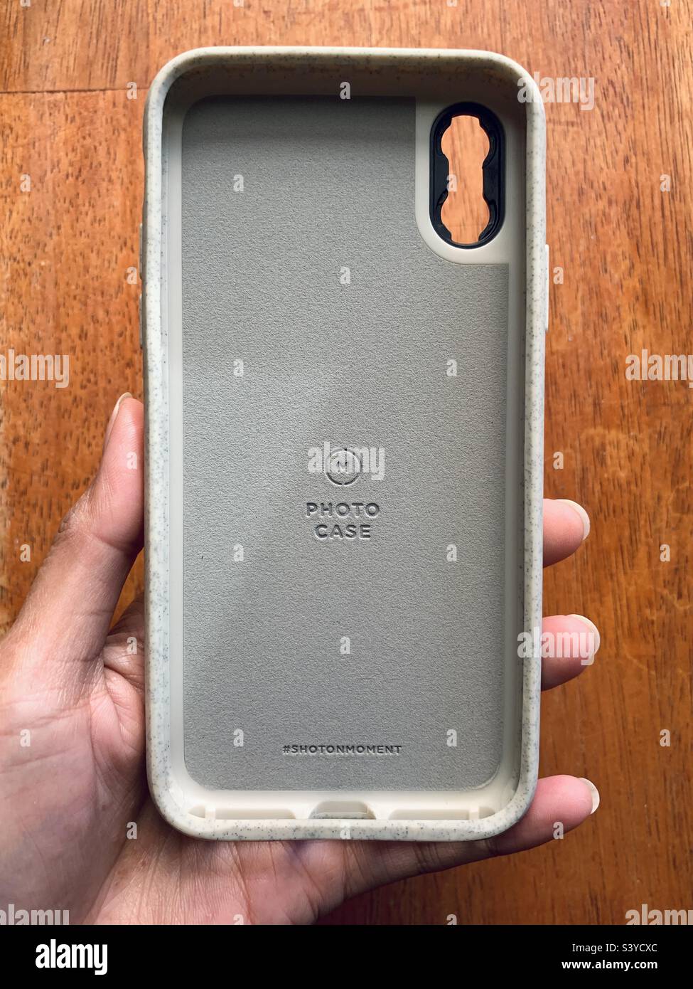 A person holding a moment rugged case for iPhone XS Stock Photo