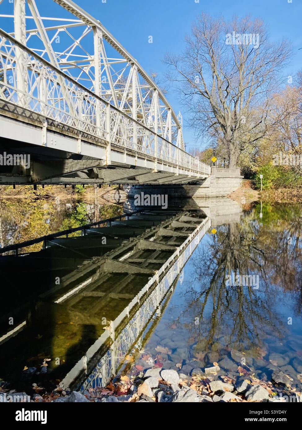 Fall reflection in the Rideau River of the vintage Minto Bridge. - Smartphone Captured Stock Image