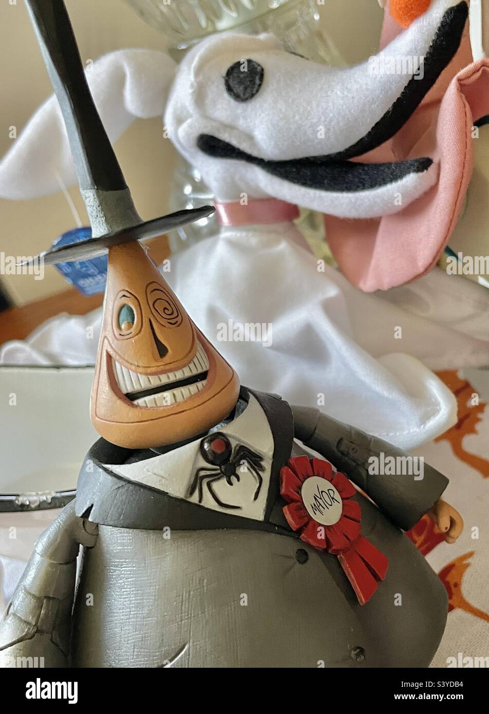 Nightmare Before Christmas character dolls, the Mayor and Zero, on a living room end table as Halloween decor in a home in Utah, USA. - Smartphone Captured Stock Image