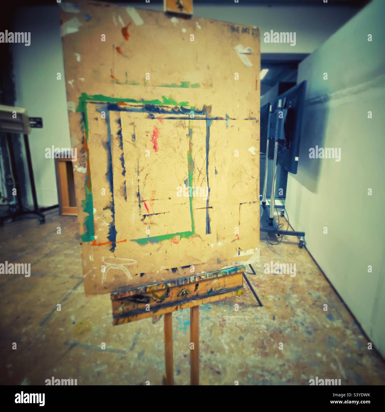 A photograph of a messy art easel in a studio - Smartphone Captured Stock Image
