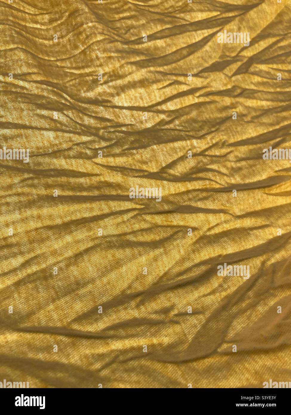 A yellow wrinkled wavy fabric surface - Smartphone Captured Stock Image