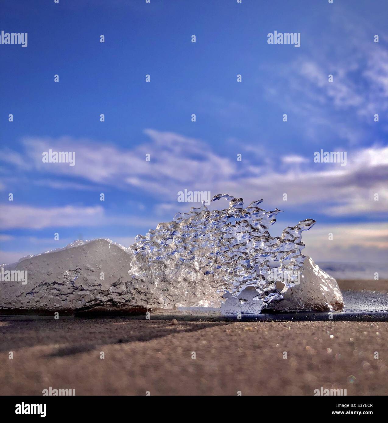 Melting ice block on sidewalk Stock Photo Alamy
