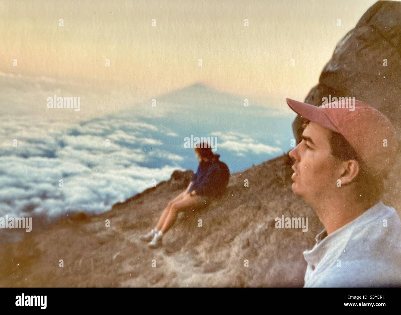Me and a friend on top of the Holy mountain of Gunung Agung in Bali with a shadow of the peak in the background. - Smartphone Captured Stock Image