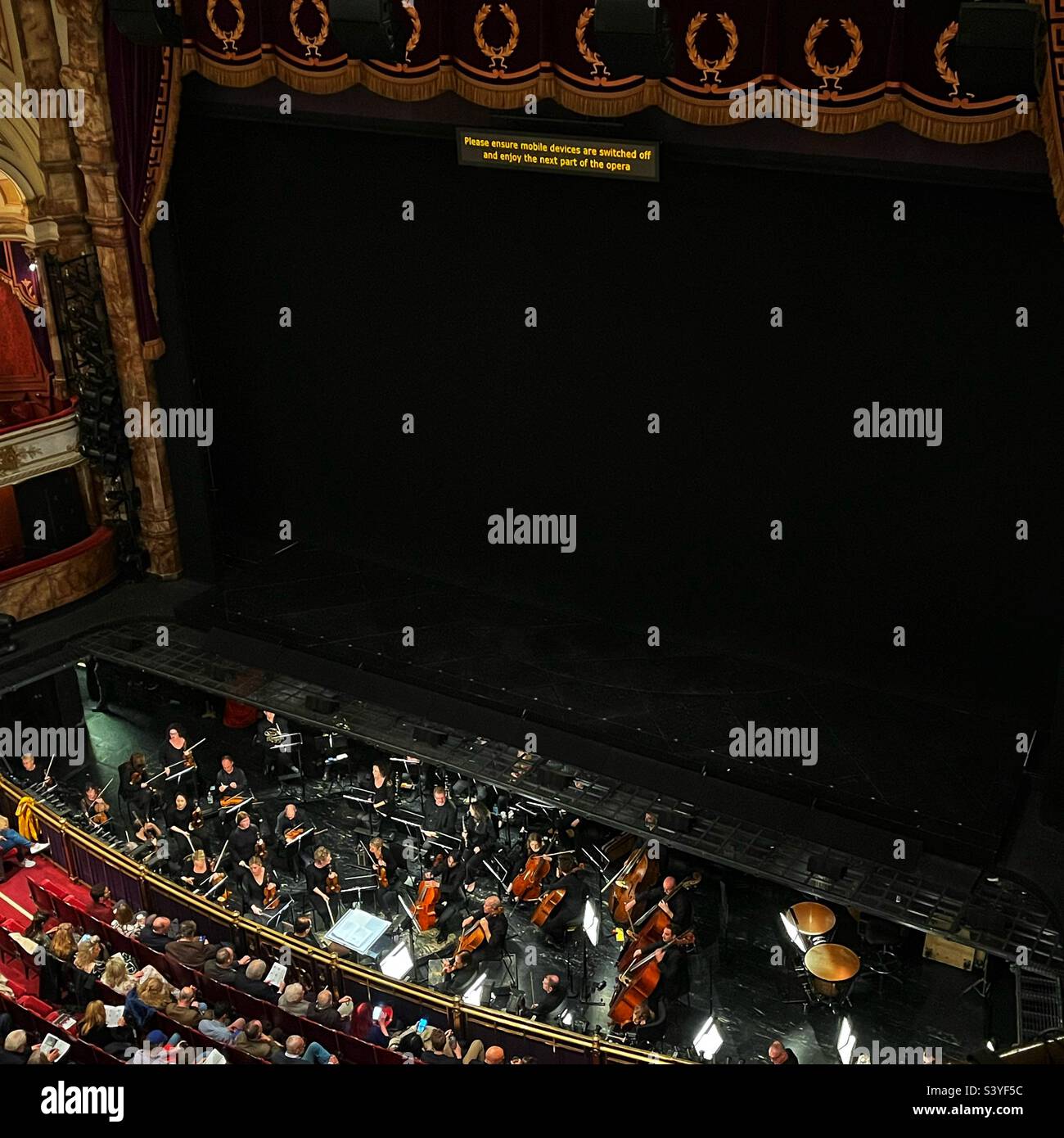 The orchestra pit at the Coliseum in London. Getting ready to perform Yeoman of the Guard. - Smartphone Captured Stock Image