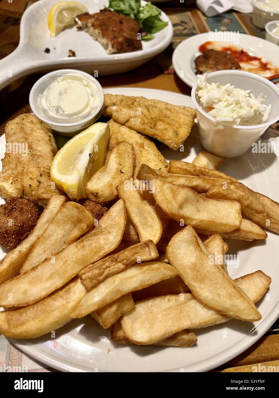 French fries and fried fish plate. Fish and chips. Stock Photo