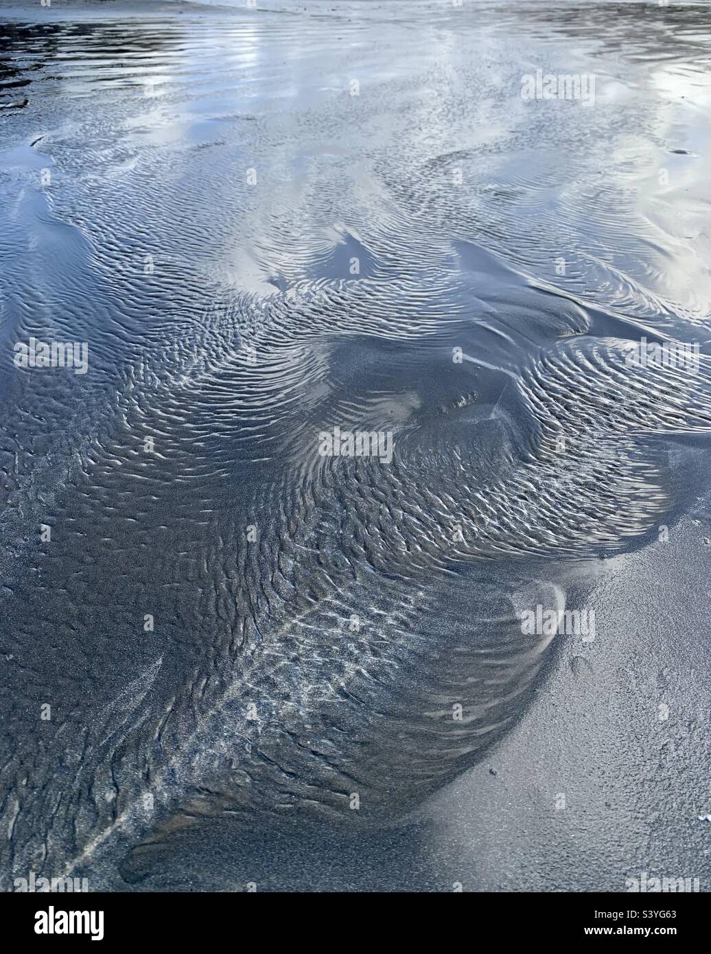 Ripples in shallow water on sandy beach - Smartphone Captured Stock Image