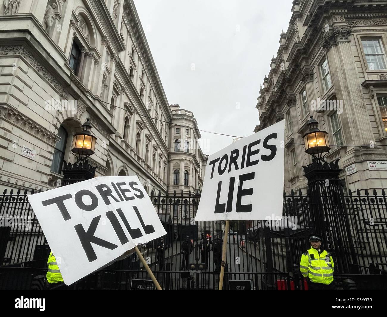 Tories Kill, Tories Lie placards seen outside Downing Street, London, SW1 - home of the Prime Minister in the UK - Smartphone Captured Stock Image