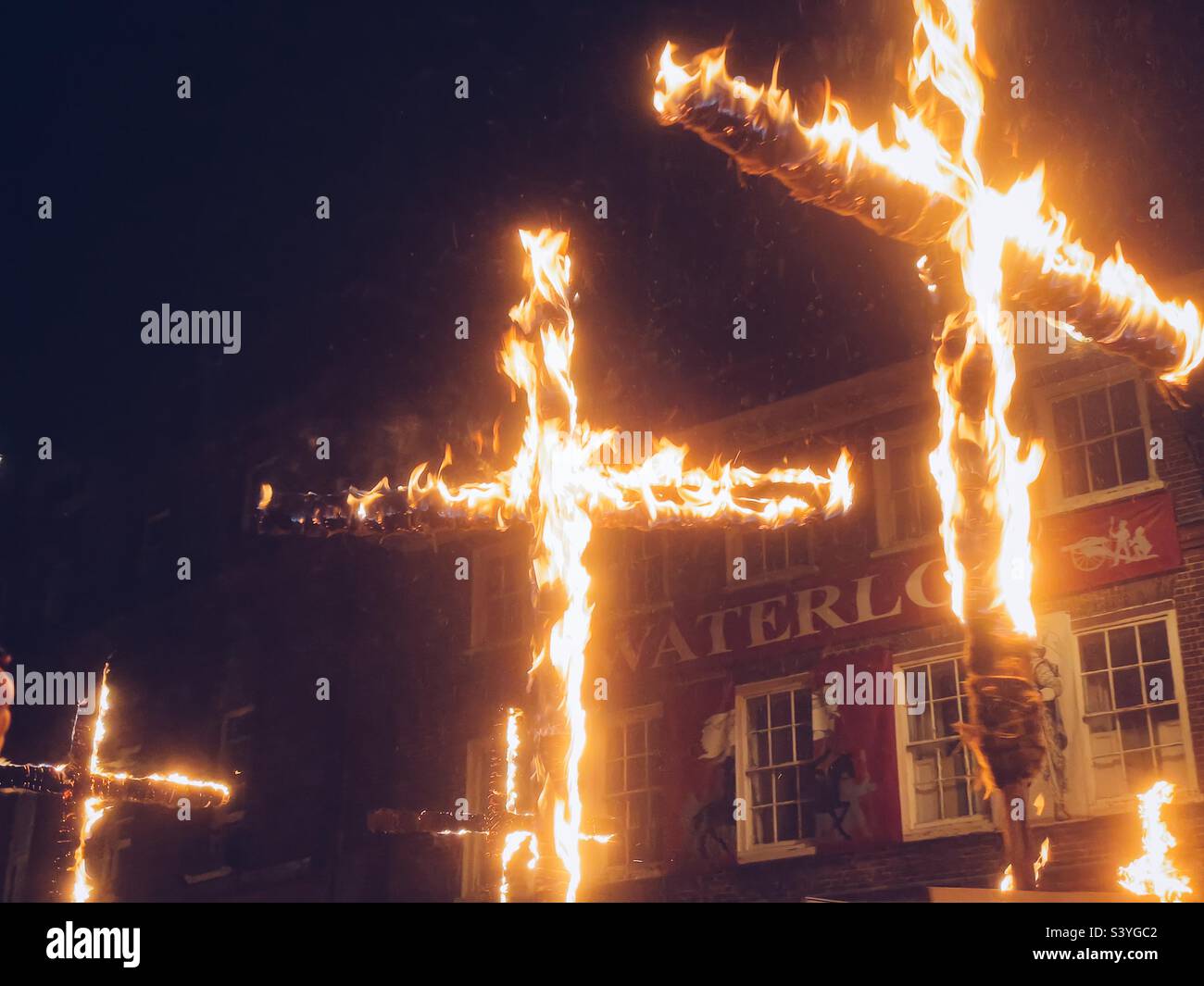 17 burning crosses are carried through Lewes to commemorate the 17 Lewes martyrs. November 5th 2022 - Smartphone Captured Stock Image