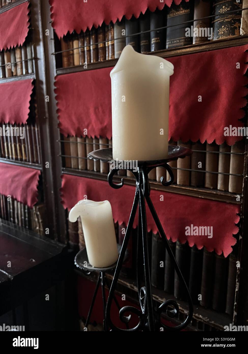 Old melting candles in front of some ancient books Stock Photo Alamy