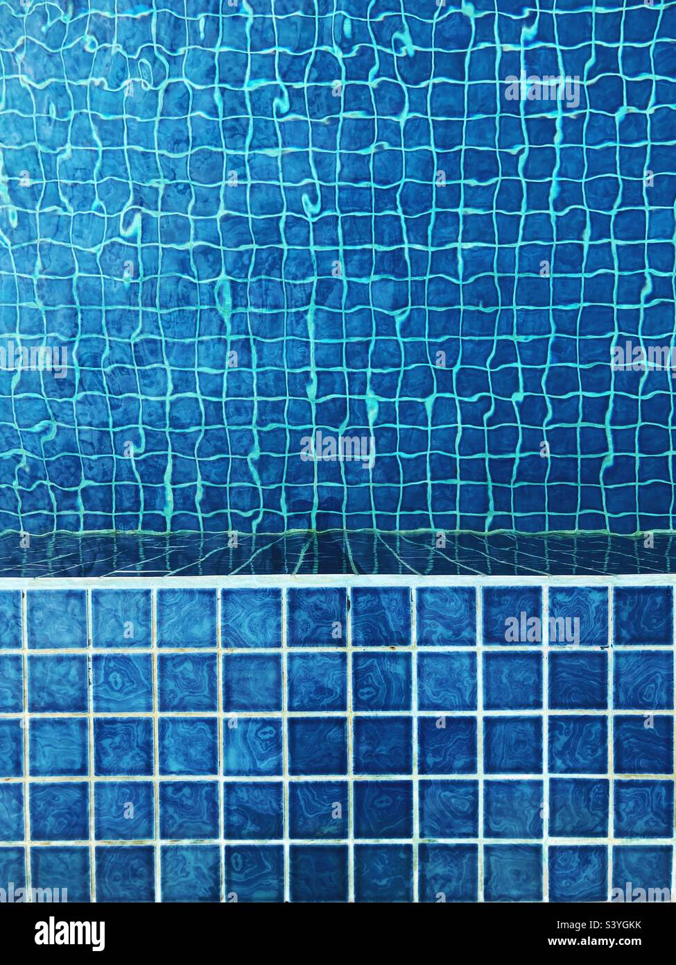 Blue tiles at the edge and within a swimming pool - Smartphone Captured Stock Image
