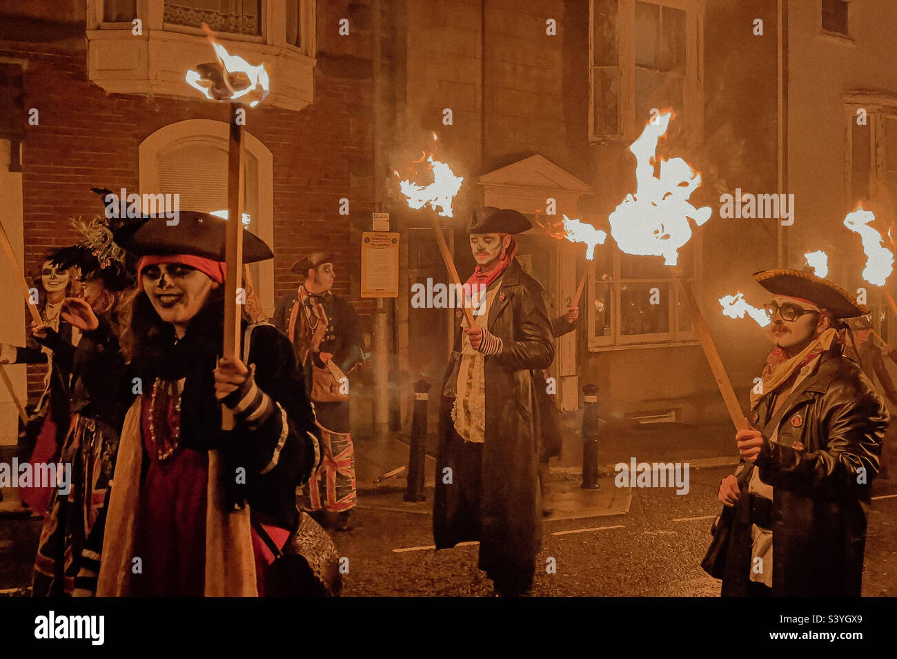 Torches alight as bonfire society marchers wait for the Lewes parade, November 5th 2022 - Smartphone Captured Stock Image