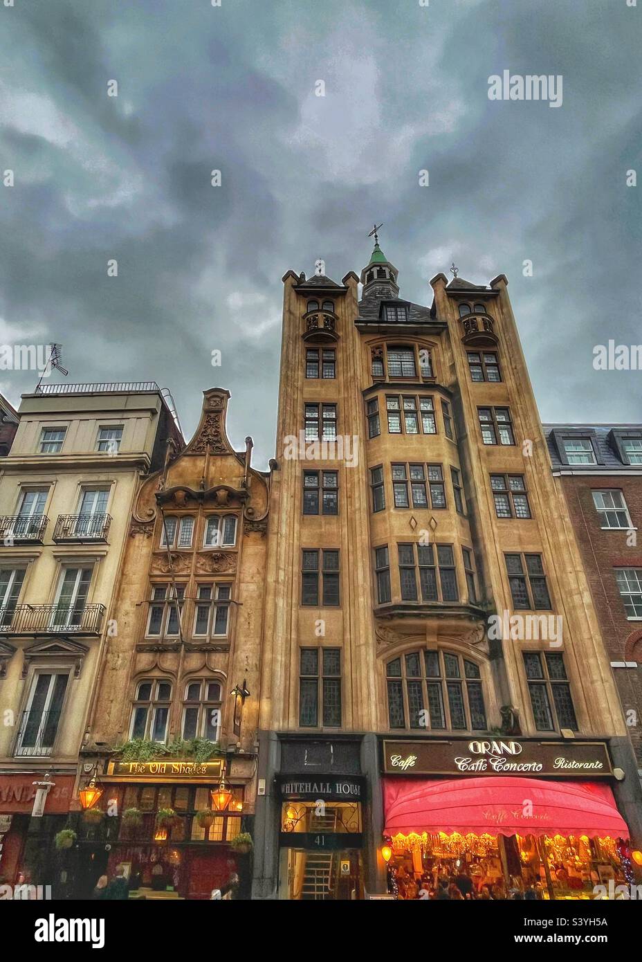 The Old Shades pub - in London, Whitehall at dusk. A Grade II listed public house at 37–39 Whitehall, London SW1. Edwardian Architecture dated 1898 next to the taller Whitehall House, number 41 - Smartphone Captured Stock Image
