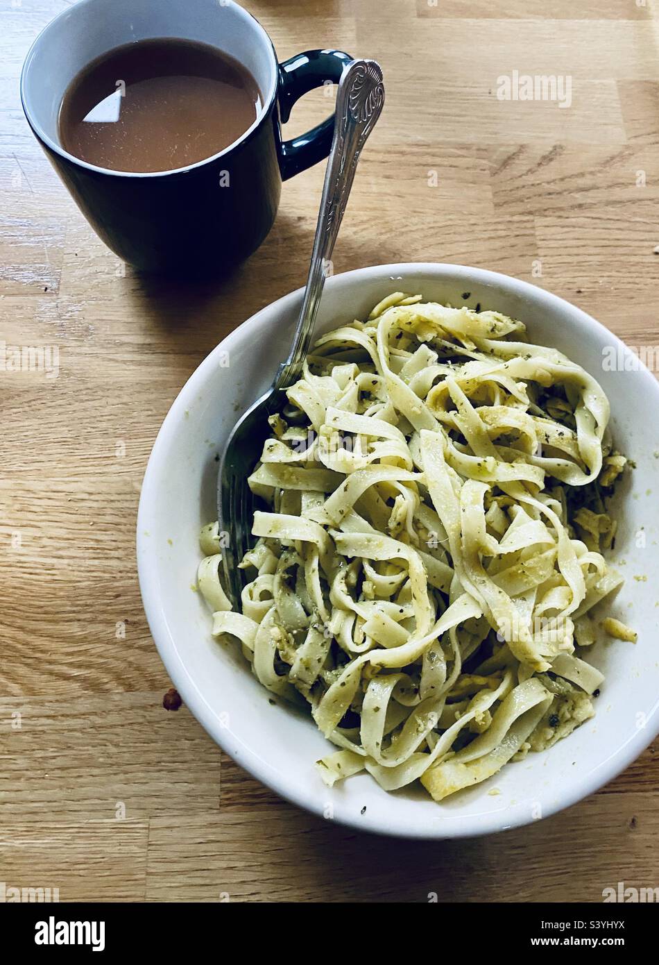 Green pesto tagliatelle and a cup of tea Stock Photo Alamy