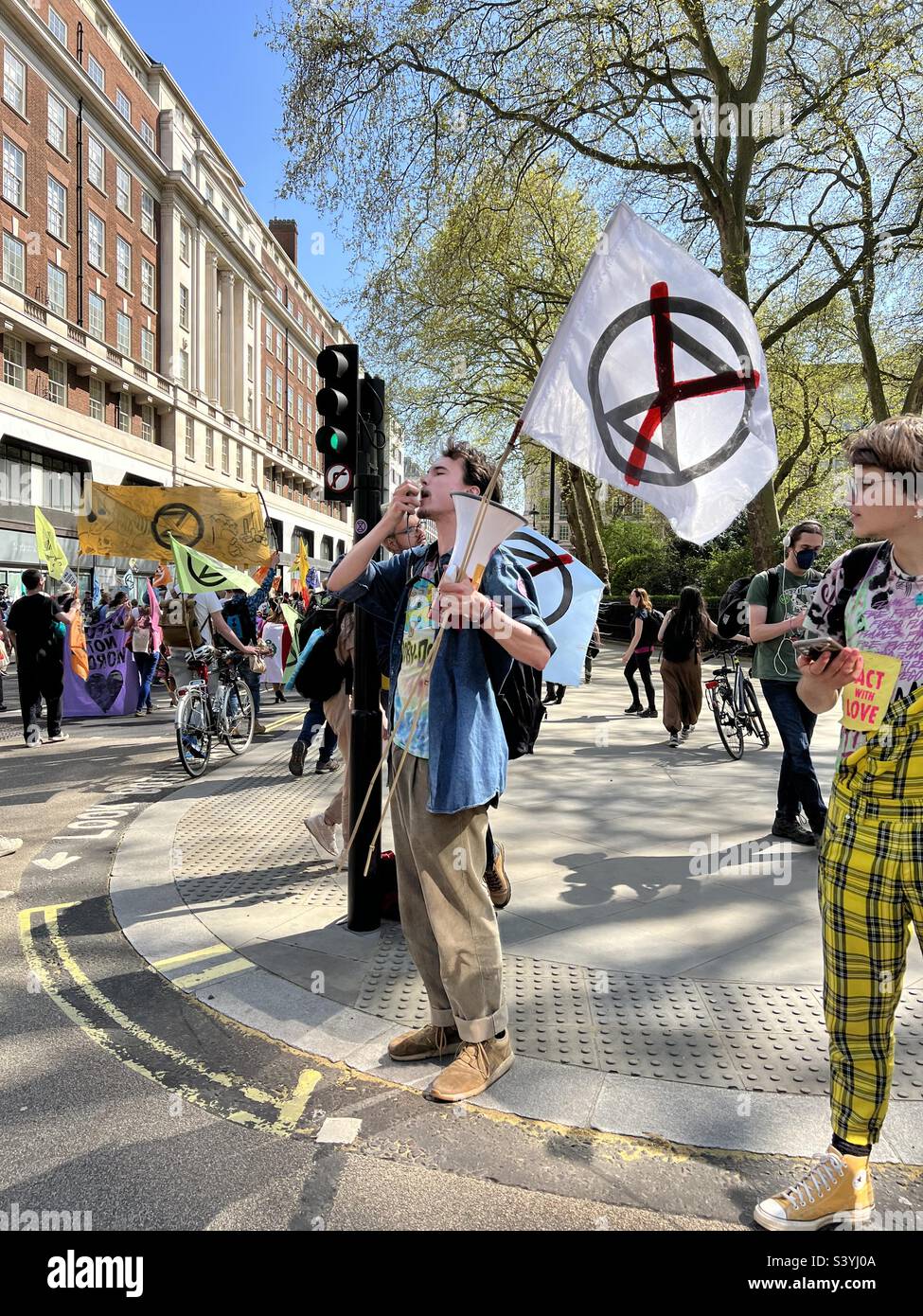 A Extinction Rebellion Youth Protestor Chanting On a Megaphone. Stock Photo