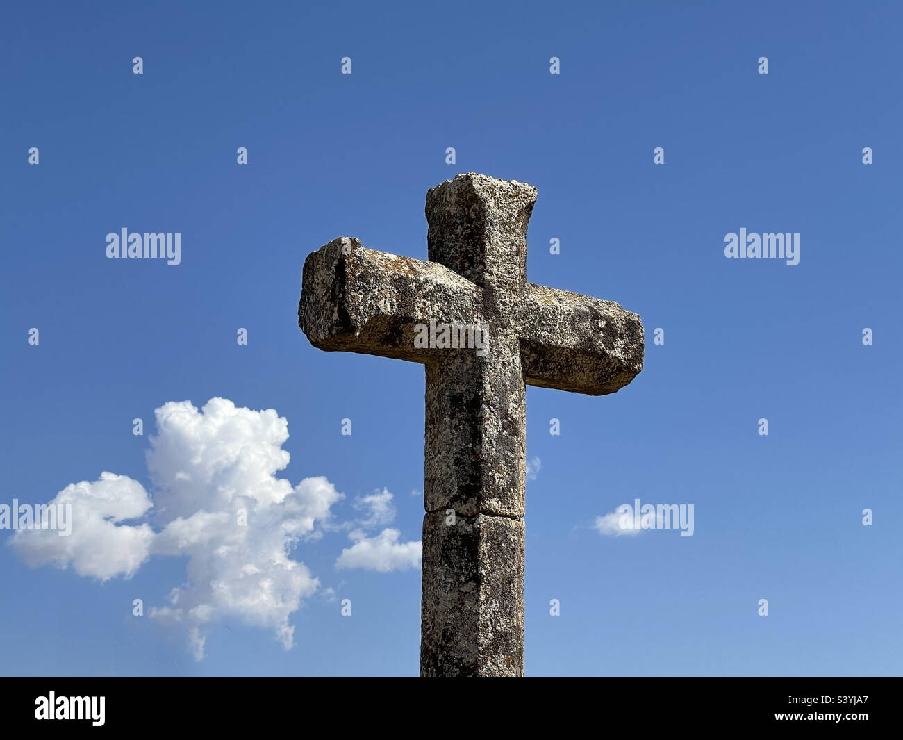 Stone cross over blue sky. - Smartphone Captured Stock Image