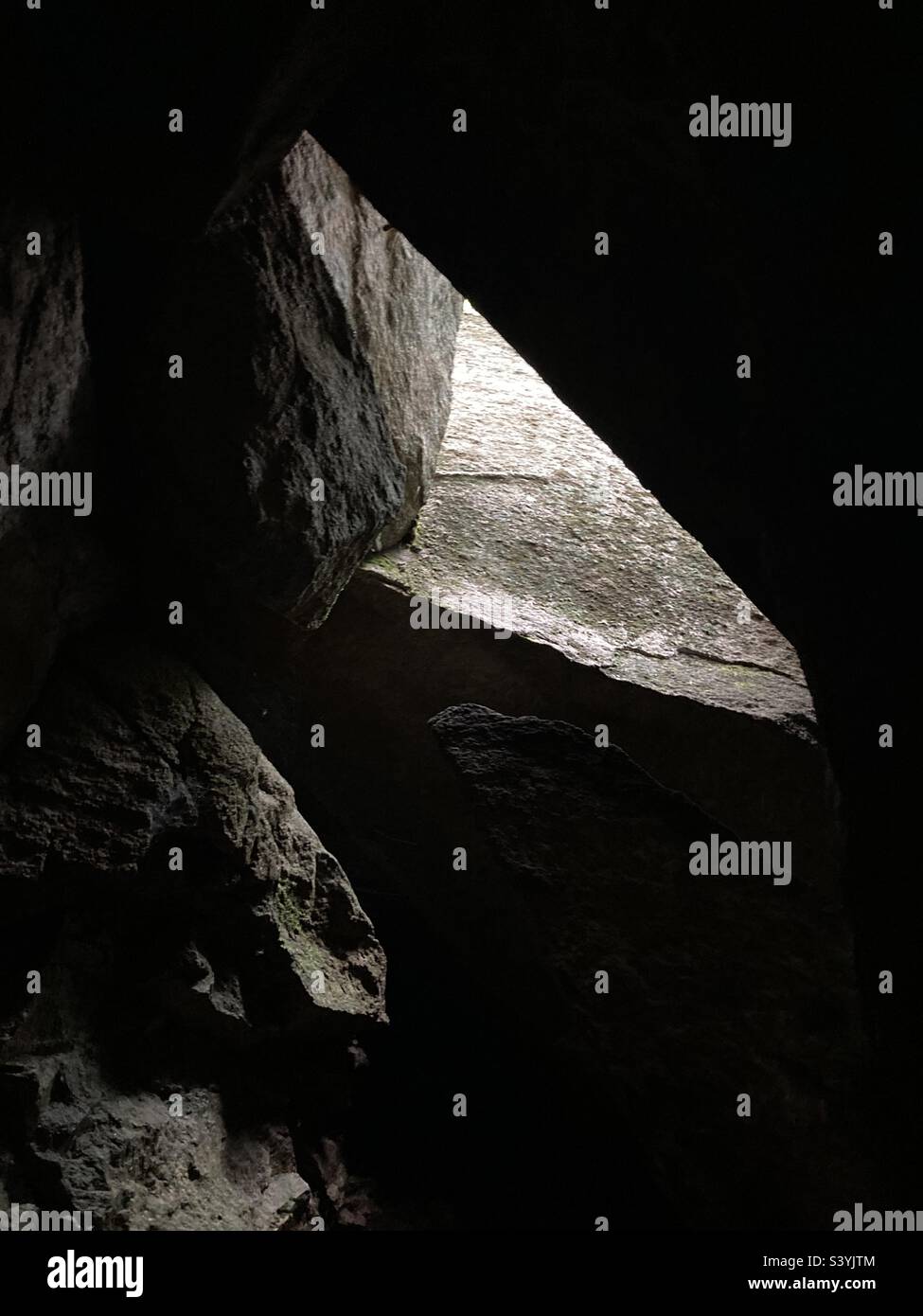 Light coming through an opening in a New Hampshire cave - Smartphone Captured Stock Image Light coming through an opening in a New Hampshire cave - Smartphone Captured Stock Image