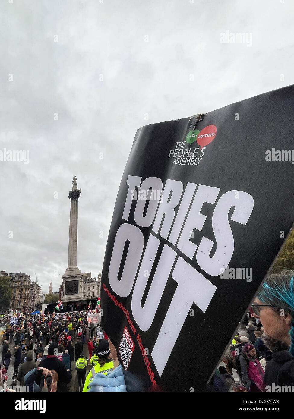 Demonstration in Trafalgar Square, banner or placard reads: ‘Tories Out’ from People’s Assembly. Nelson’s Column visible Stock Photo