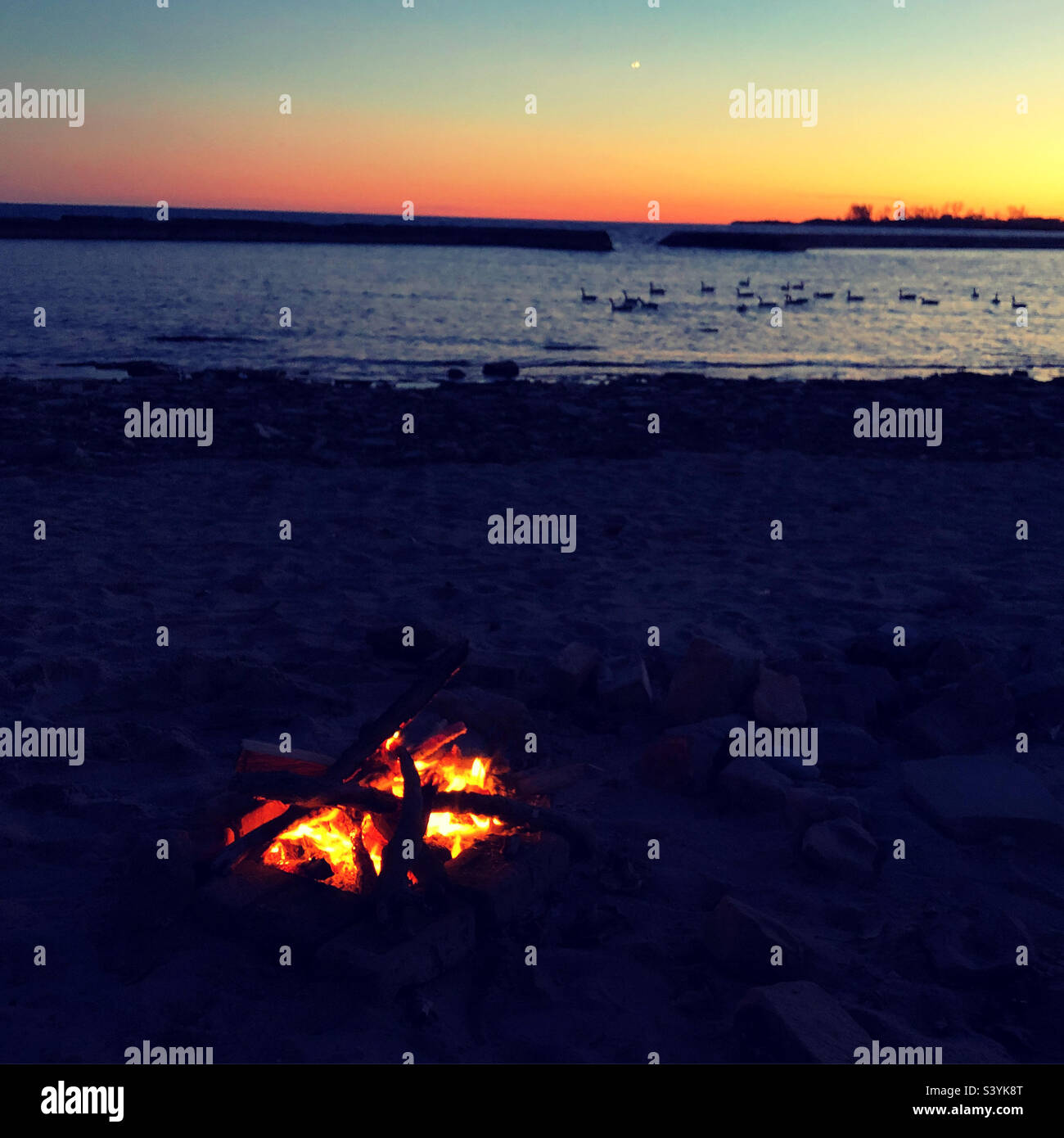 A tranquil evening on the beach at sunset. - Smartphone Captured Stock Image