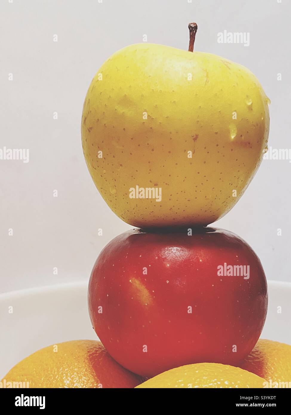 Apples and oranges against white background Stock Photo Alamy