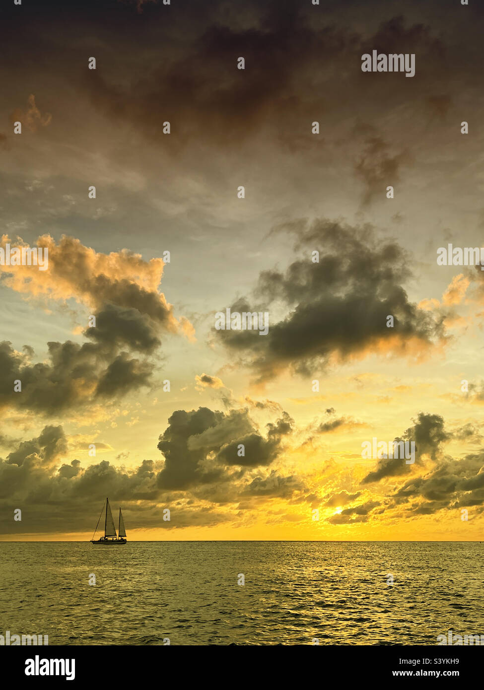 Gulf of Mexico sunset with sail boat in horizon - Smartphone Captured Stock Image