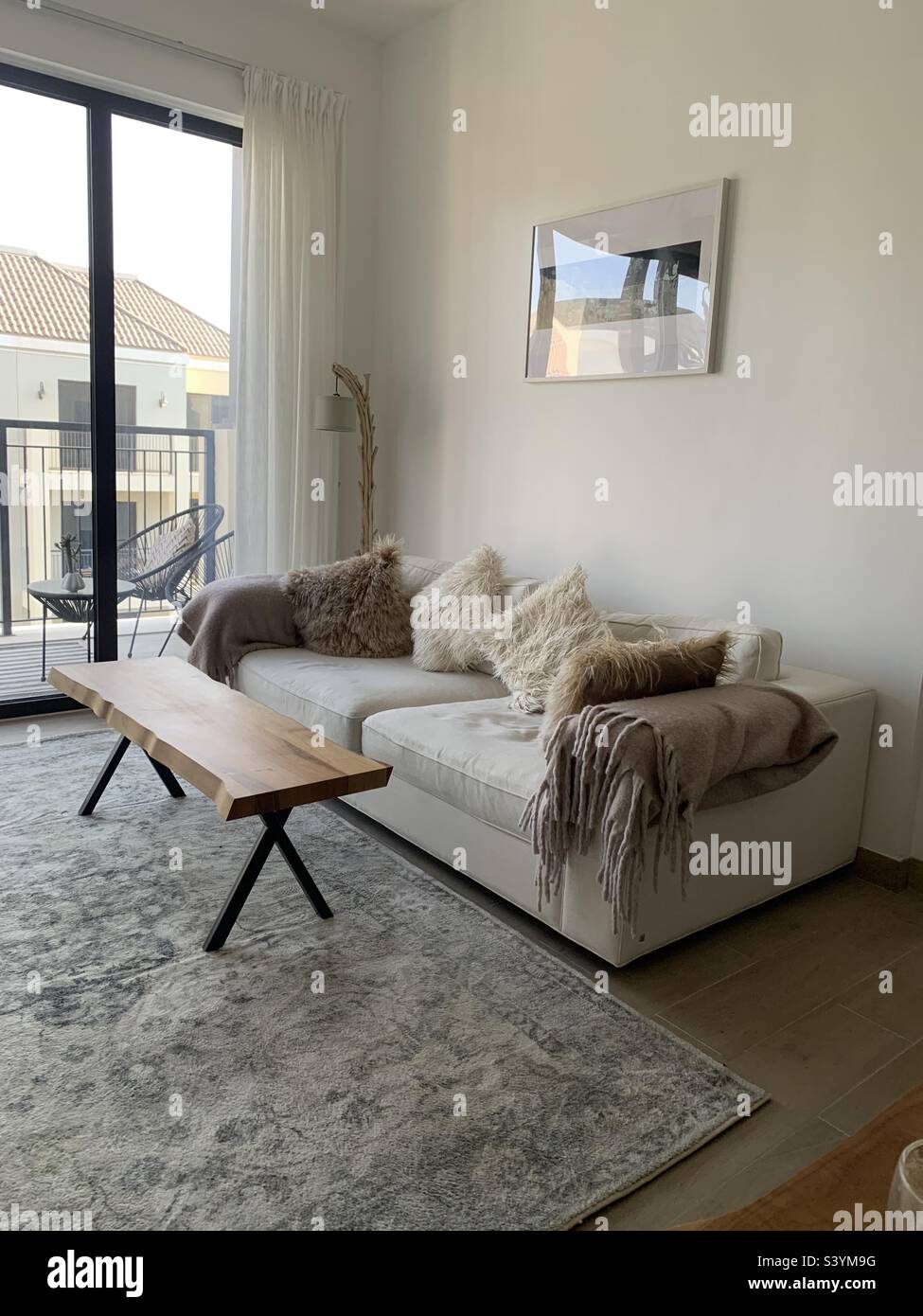 Stylish sofa and coffee table in an open plan living room view a view of the balcony - Smartphone Captured Stock Image