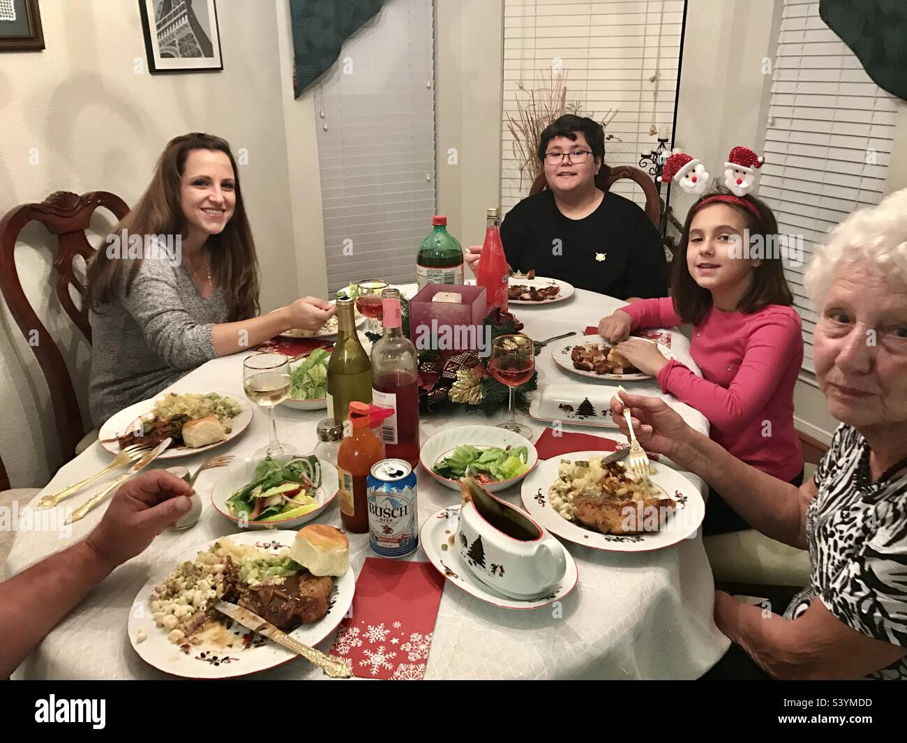 A family sitting around the table for Christmas dinner Stock Photo