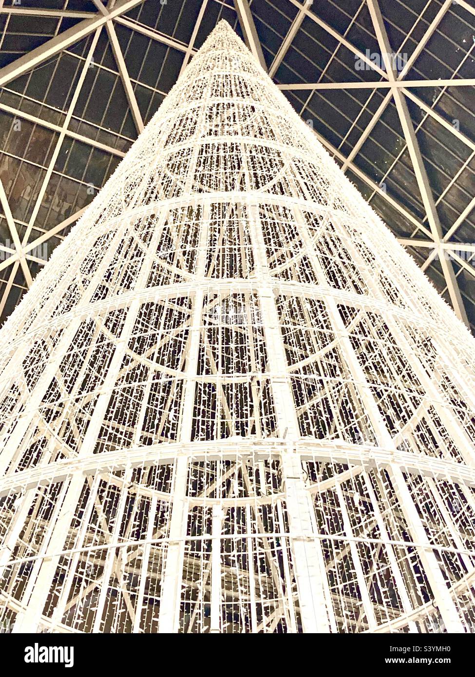 Looking up at an unlit giant Christmas tree inside a shopping centre - Smartphone Captured Stock Image