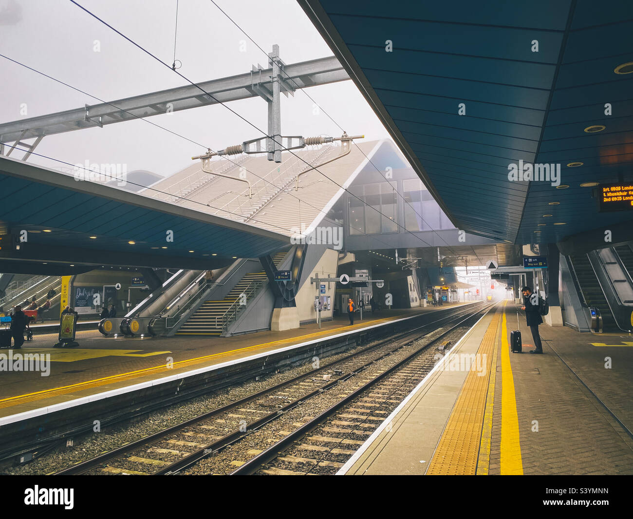 Waiting on the platform at Reading Railway Station for a train to arrive. - Smartphone Captured Stock Image