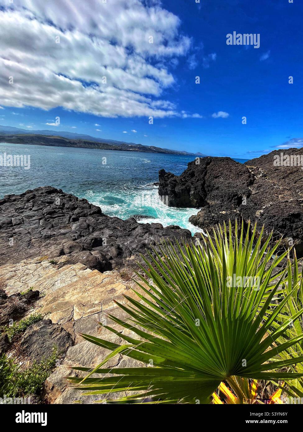 Inlet on the cliff at La Isleta Las Palmas Gran Canaria waves of the Atlantic Ocean rush in - Smartphone Captured Stock Image