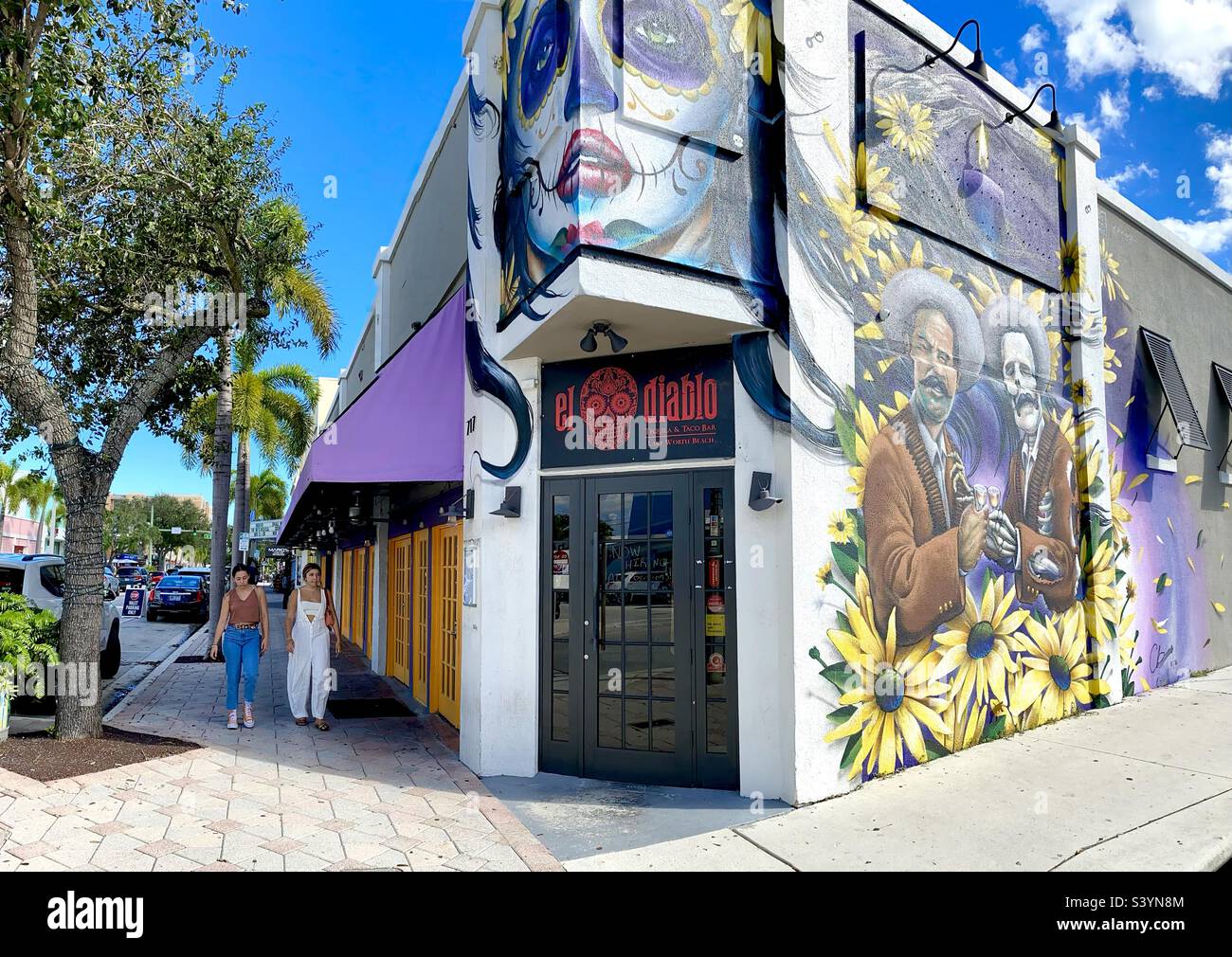 El Diablo tacos and tequila bar in downtown Lake Worth Beach, Florida, mural and street scene with residents on the street. - Smartphone Captured Stock Image
