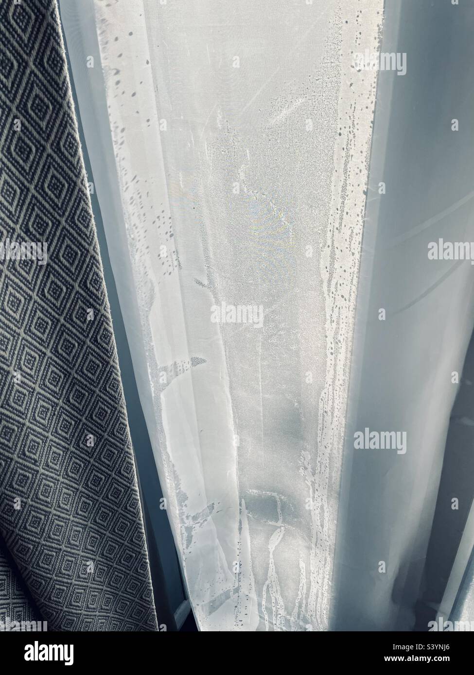 Voile curtains stuck to the condensation build up on glass garden doors no heating on due to