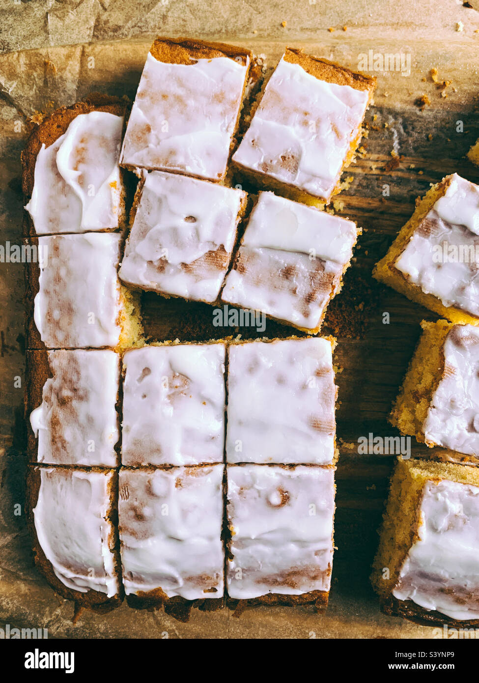 Tray bake sponge with icing cut into square pieces - Smartphone Captured Stock Image