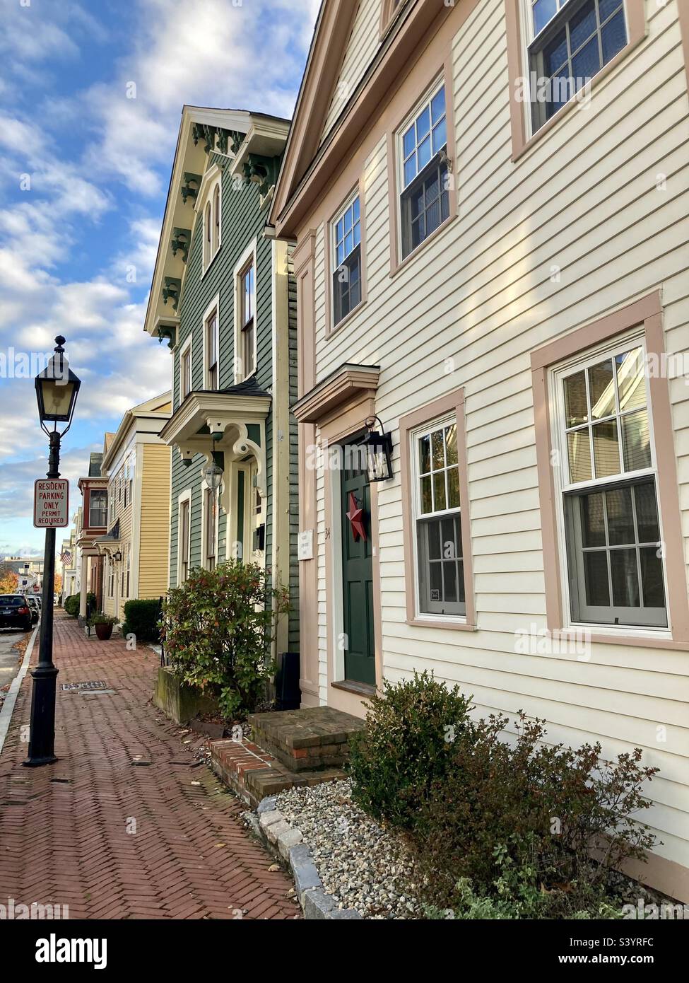 New London, Connecticut’s historic district of Starr Street during November of 2022. View  of street with houses and lamppost. - Smartphone Captured Stock Image