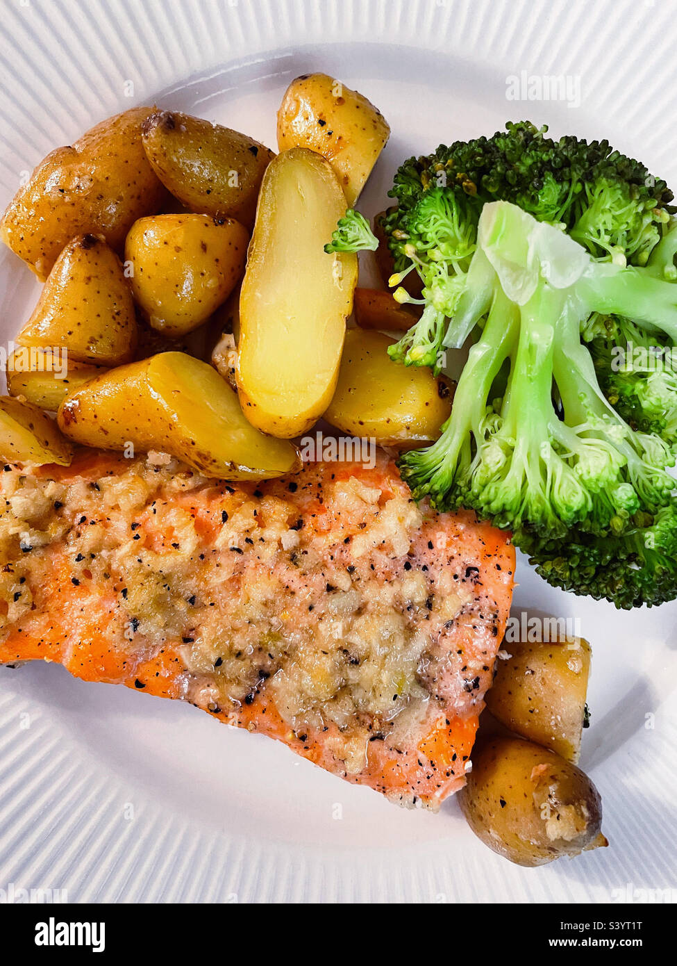 Flat lay of a main course entrée of salmon fillet, new potatoes and steamed broccoli, 2022, USA - Smartphone Captured Stock Image