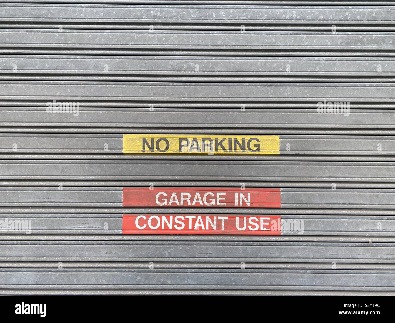 No parking garage in constant use sign - Smartphone Captured Stock Image