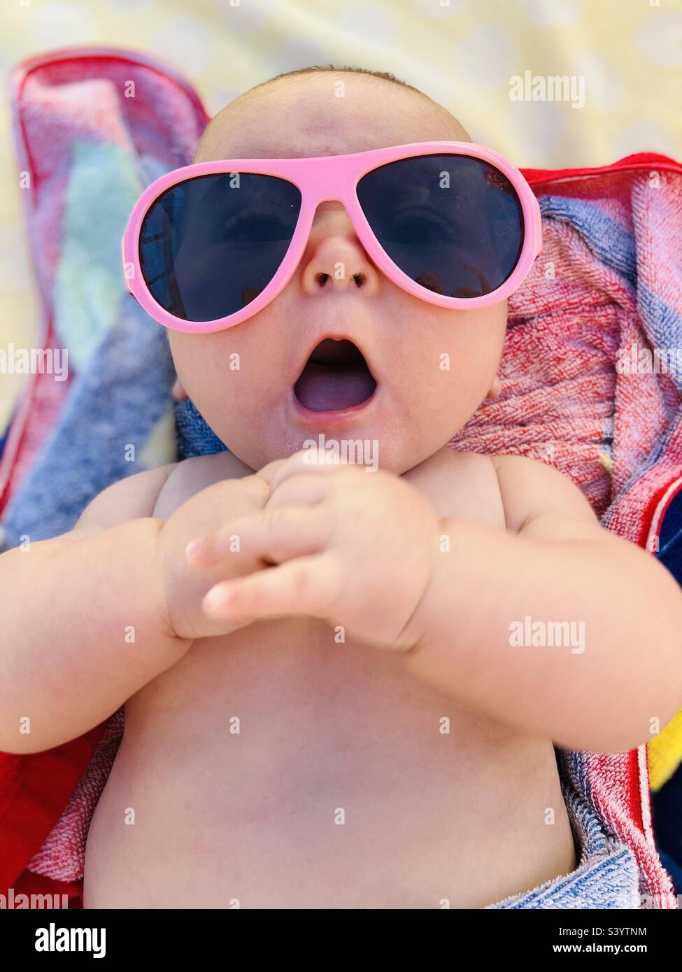 Baby girl in pink sun glasses Stock Photo