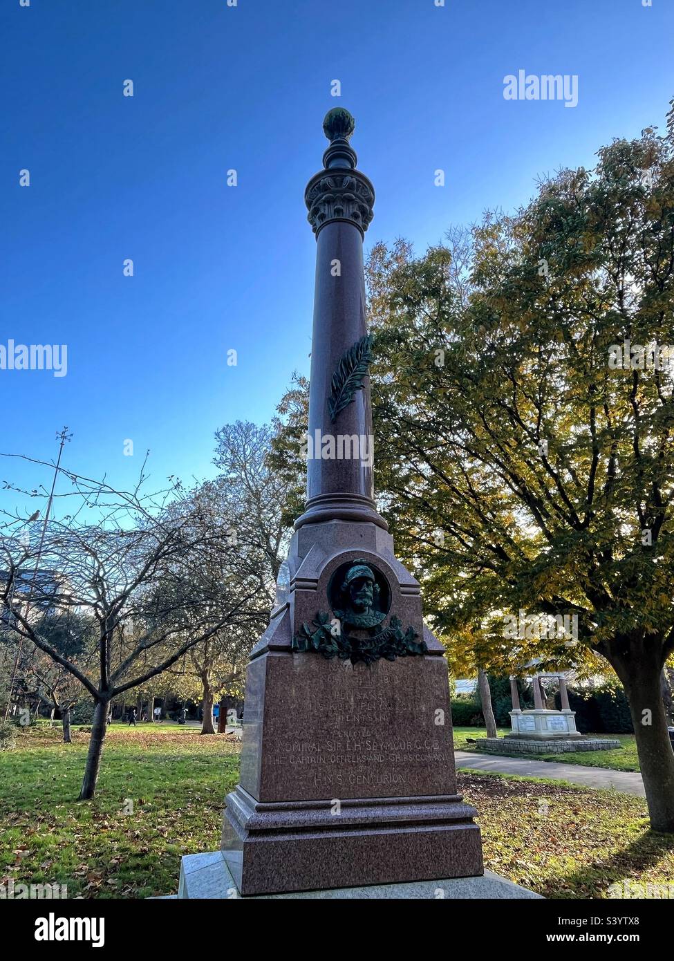 round column surmounted by sphere, white and red granite, head of centurion on round column dedicated to the crew of HMS Centurion who fought in China during the ‘Boxer Riots’ at the turn of C20th Stock Photo