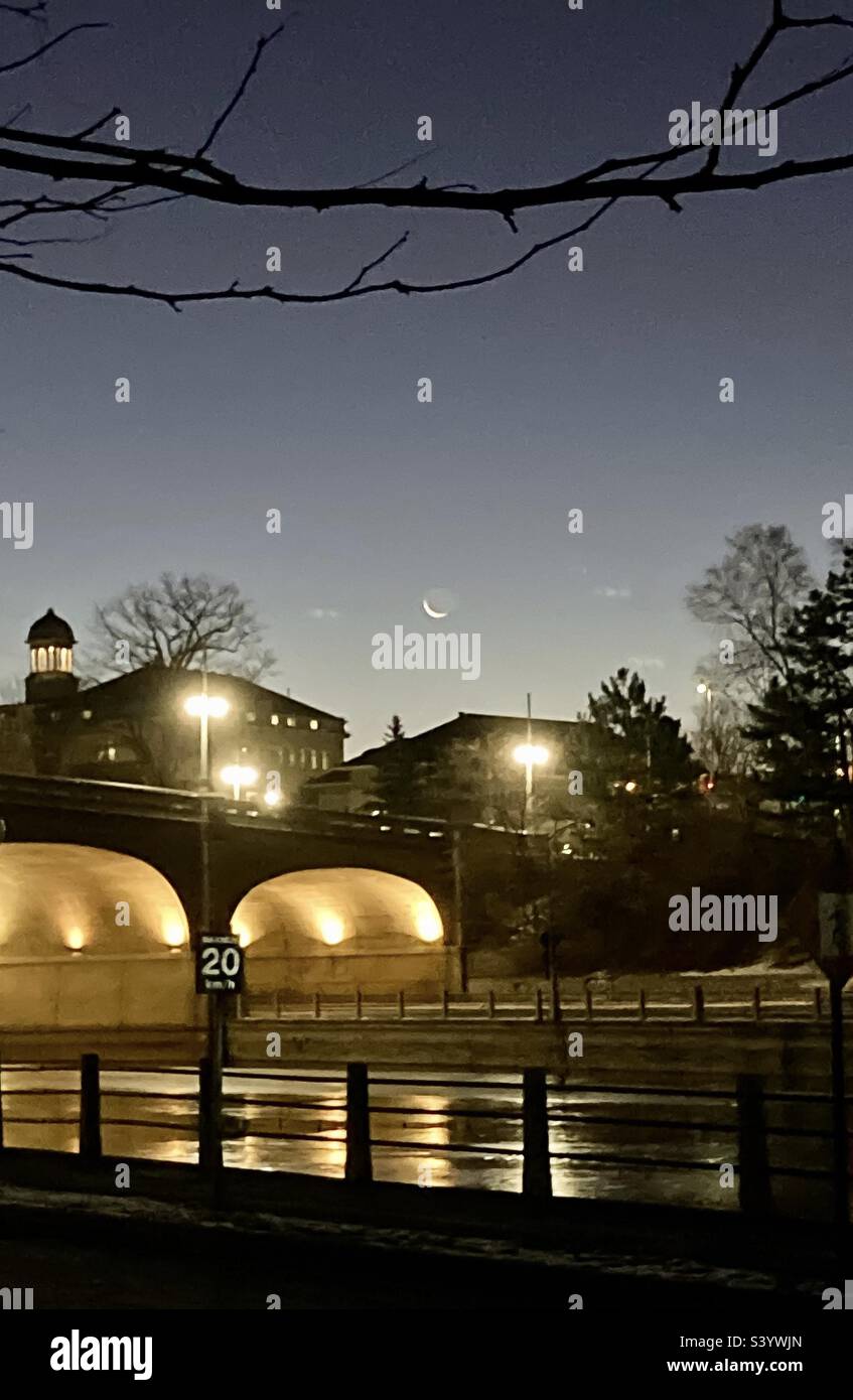 Dawn over the drained Rideau Canal with a sliver moon. - Smartphone Captured Stock Image